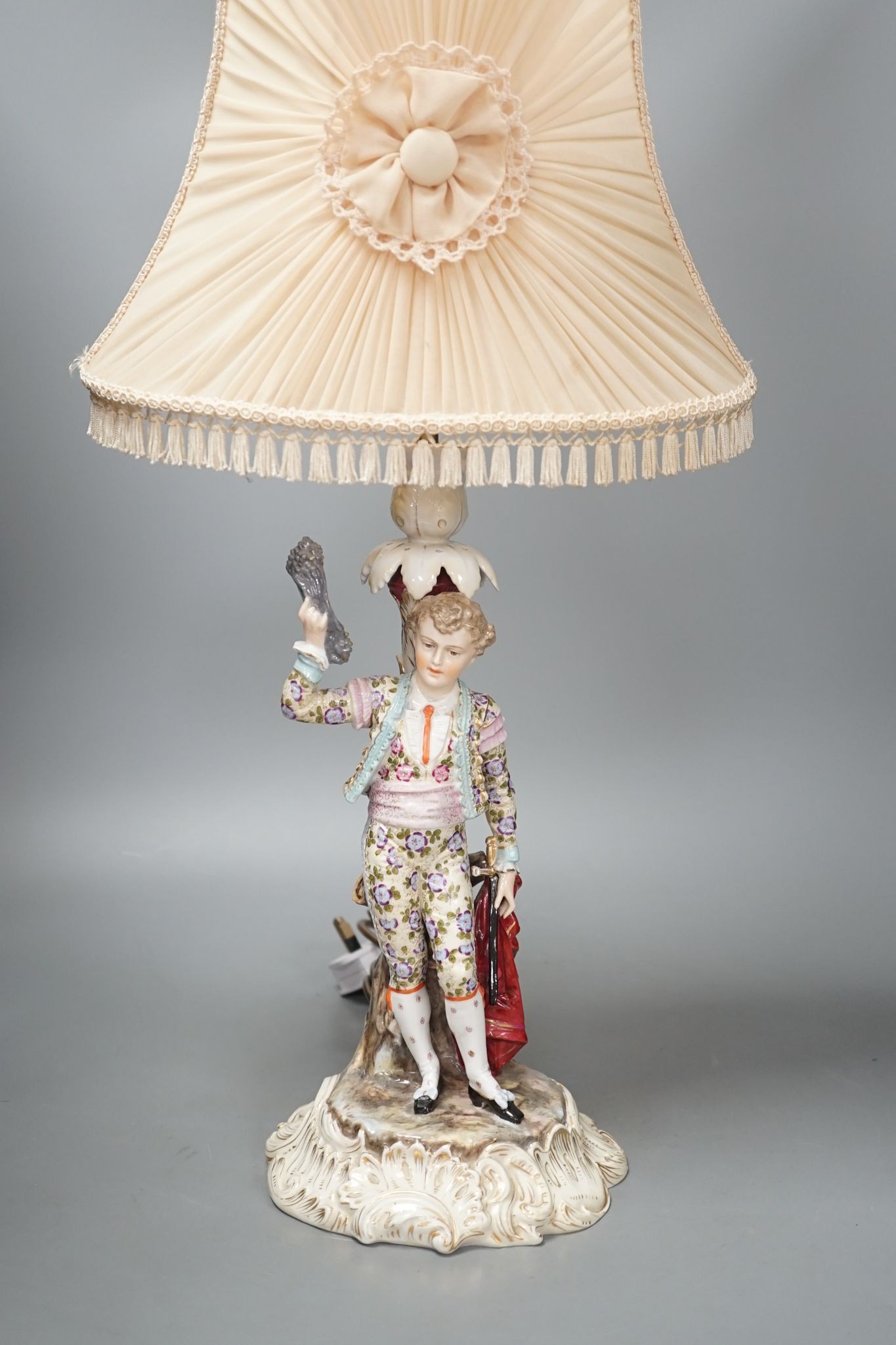 A German porcelain 'matador' lamp and shade 57cm total